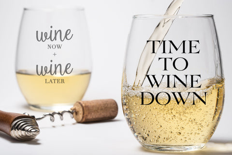 Clear stemless wine glass with the text imprinted "time to wine down".